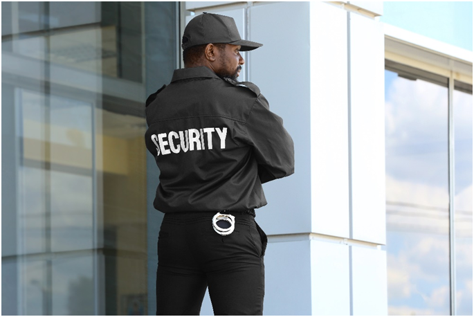 A security guard standing in front of a building.