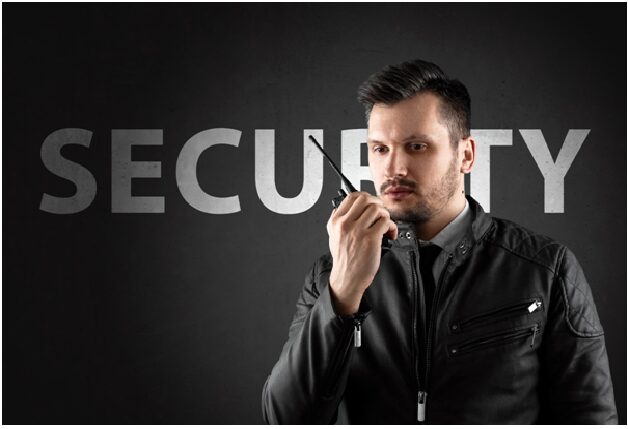 A man in black jacket holding a cell phone.