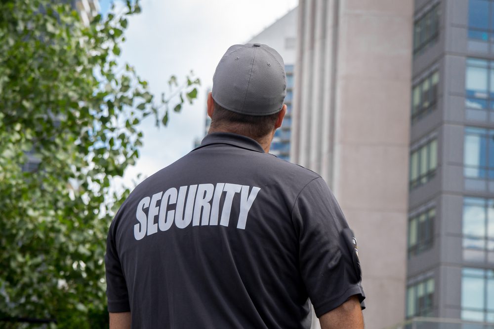 A security guard standing in front of a building.