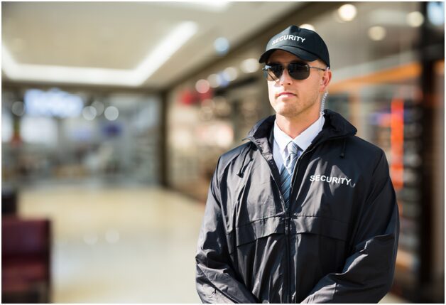 A man in black jacket and white shirt wearing sunglasses.