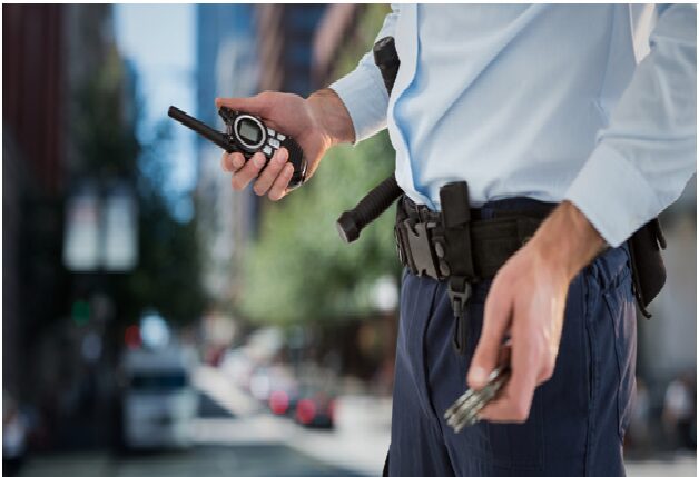 A man holding two cell phones in his hand.